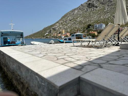 a group of chairs and umbrellas on a dock at Villa Sylvia in Symi