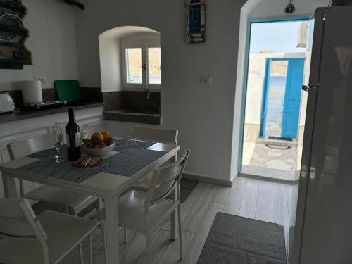 a kitchen with a table with a bowl of fruit on it at Villa Sylvia in Symi