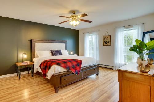 a bedroom with a bed and a ceiling fan at Freeville Home with Covered Porch Near Cayuga Lake! in Freeville