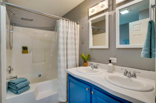 a bathroom with two sinks and a shower and a tub at Freeville Home with Covered Porch Near Cayuga Lake! in Freeville
