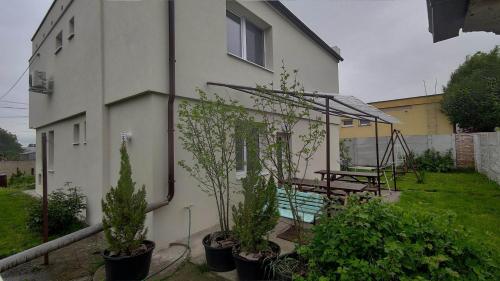 a house with a table and plants in a yard at Vila Gajdo in Tvrdošovce