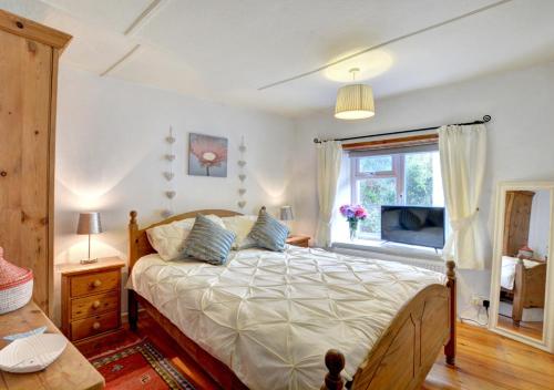 Postel nebo postele na pokoji v ubytování Merryn Cottage