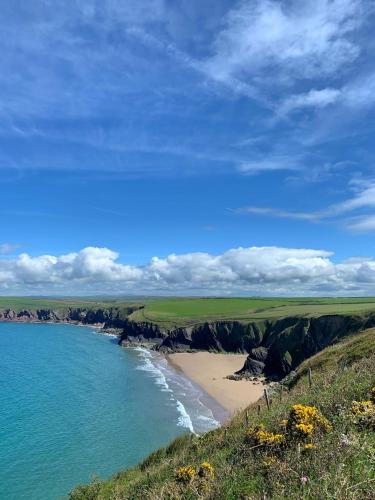 a view of a beach with the ocean at Beaufighter in Haverfordwest