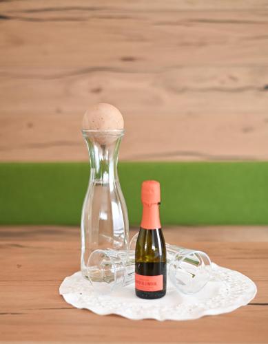 a bottle of wine sitting next to a glass siphon at Boutique Pension Erlacher - Adults Only in Villandro