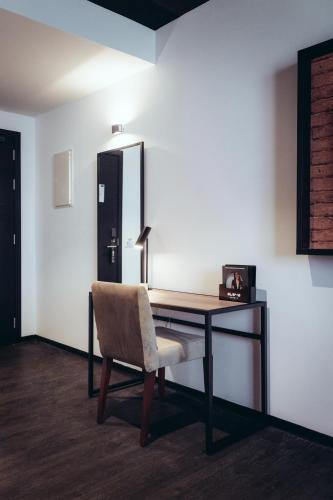 a desk with a chair and a mirror on a wall at ONOMO Hotel Casablanca Sidi Maarouf in Casablanca