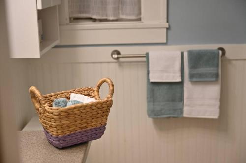 a basket of towels on a counter in a bathroom at U-District Warmth 8 mins walk to UW in Seattle