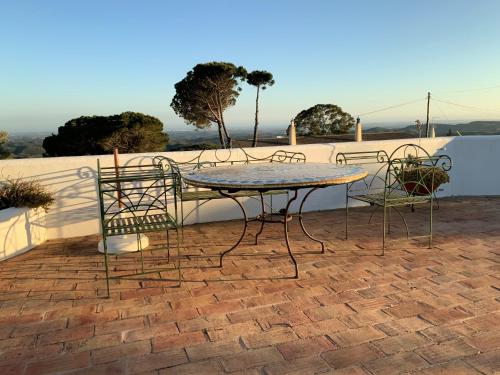 a table and chairs sitting on a brick patio at Montanha Vista in Monchique