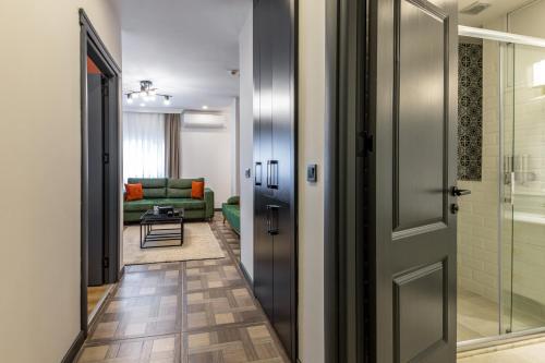 a hallway with a door leading to a living room at BayMari Suites City Life in Istanbul