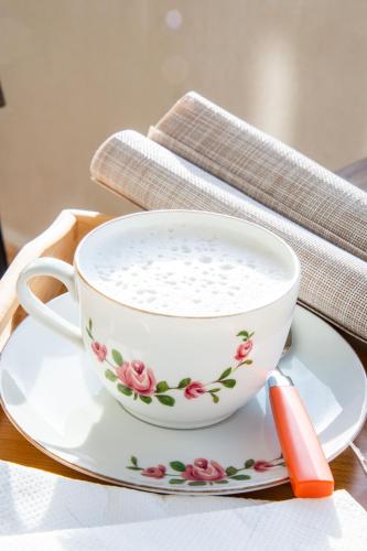 a coffee cup on a plate on a table at B&B BABBU MEU in Bosa