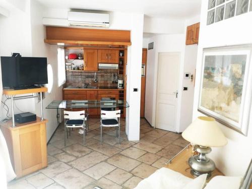 a kitchen with a table and a tv in a room at Open space with sea view close to the Croisette in Cannes