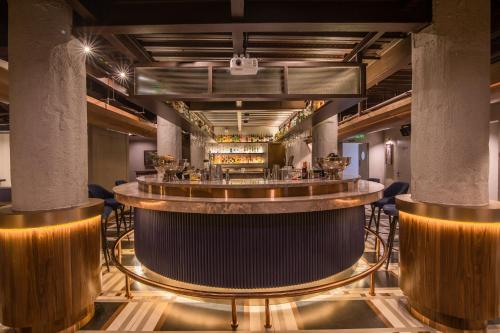 a view of a bar in a room with columns at 37th Crescent Hotel Bengaluru in Bengaluru