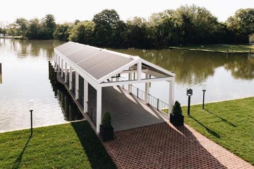 a pavilion on the side of a body of water at The Oaks Waterfront Hotel in Saint Michaels