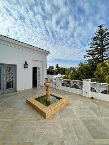 a large patio with a fountain in the middle at Dar El Gaied in Nabeul