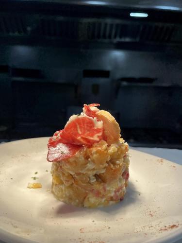 a piece of food sitting on a white plate at Hostal de la Plaça - Hotel Boutique in Cabrils