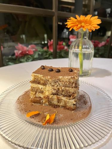 a piece of cake on a plate on a table at Hostal de la Plaça - Hotel Boutique in Cabrils