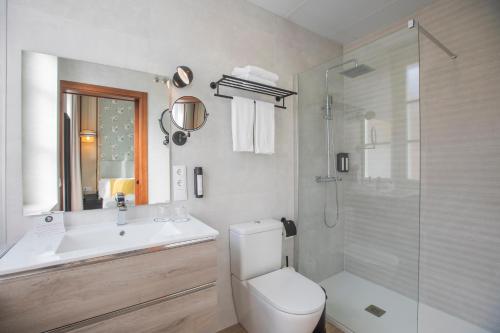 a bathroom with a toilet and a sink and a shower at Soho Boutique Columela in Cádiz