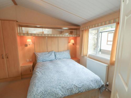 a small bedroom with a bed and a window at Stanley's Sanctuary in Cockermouth