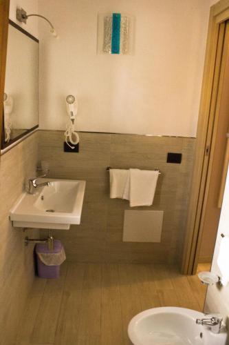 a bathroom with a sink and a toilet at Real B&B Primo Sole in Castelsardo