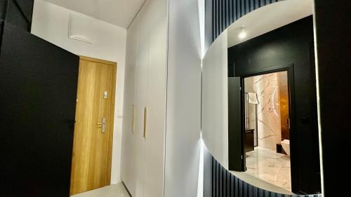 a hallway with a round mirror on the wall at ApartPark Centrum Zator Bronze in Zator