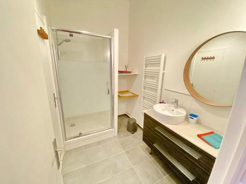 a bathroom with a shower and a sink and a mirror at Vieux Port Proximité Panier Clim Central Cachet in Marseille
