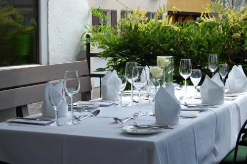 a table with wine glasses and napkins on it at Bodenseehotel Renn in Hagnau