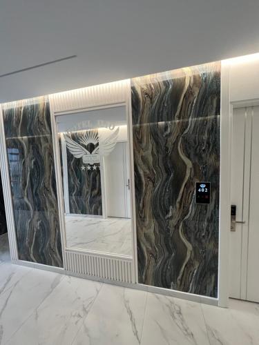 a mirror in a room with a marble wall at Ilio Boutique Hotel in Ksamil