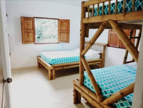 a bedroom with two bunk beds in a room at Jardín de la Inmaculada - Cabaña in Jardin