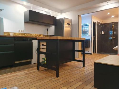een keuken met een zwart eiland in een kamer bij Villa-Port Nature-Village Naturiste-1 chambre in Cap d'Agde