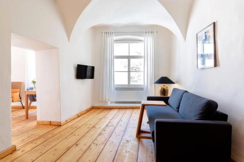 a living room with a couch and a window at Pension Goldenes Schiff in Passau
