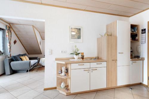 a kitchen with a refrigerator and a living room at Gieringer in Oberharmersbach