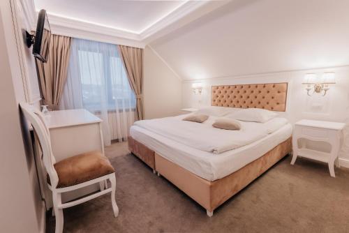 מיטה או מיטות בחדר ב-Pensiunea La Filuță