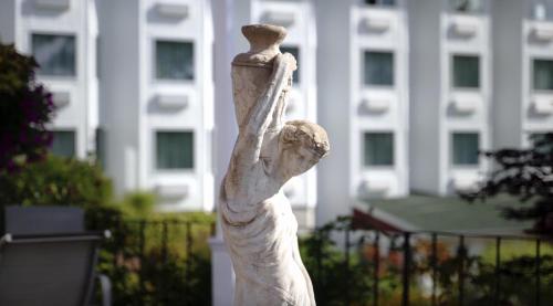 a statue of a woman with her arm in the air at Auberge Gisele's Inn in Baddeck