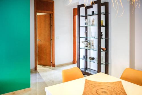 a dining room with a table and orange chairs at 15 - EL APARTAMENTO DE BAILEN - ENJOY TARIFA in Tarifa