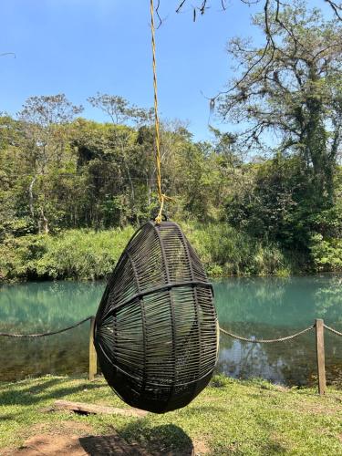 una canasta negra colgando de una cuerda junto a un río en Rancho tres Marías, en Córdoba
