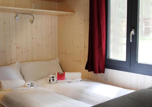 a bed in a room with a window at Camping la Pineta in Santa Maria Maggiore