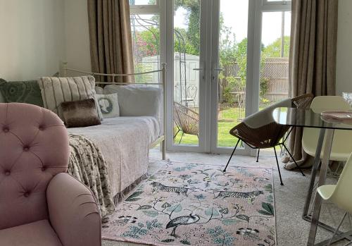 a bedroom with a bed and a chair and a table at The Broomsquire in Tadley