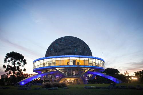 a large building with blue lights on it at Dumont Urban Studio in Buenos Aires