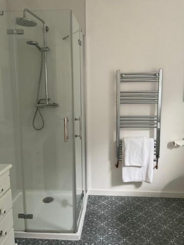 a bathroom with a shower with a glass door at The Broomsquire in Tadley