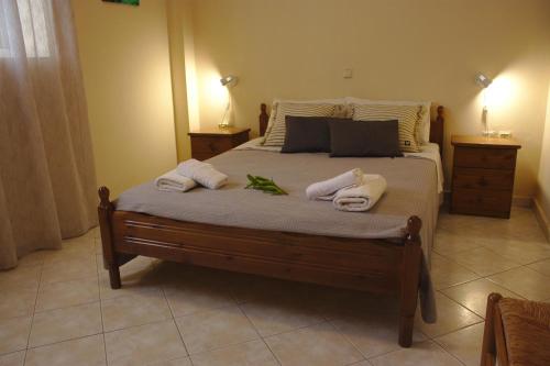 a bedroom with a bed with towels on it at Bouka Apartment in Messini