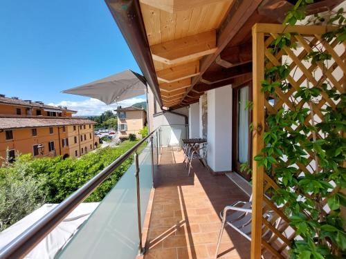 a balcony with a view of a building at Pizzocolo resort fasano in Gardone Riviera
