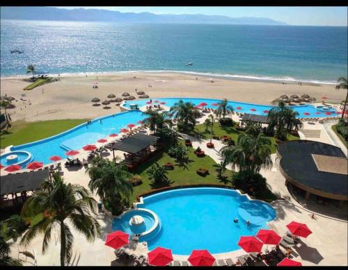 an aerial view of the pool and the beach at Ocean front Grand Venetian corner condo in Puerto Vallarta