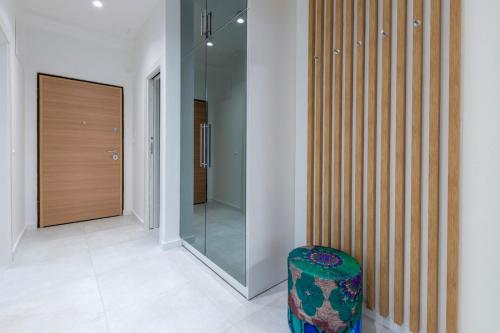 a hallway with a glass door and a stool at Split Luxury Suite in Split
