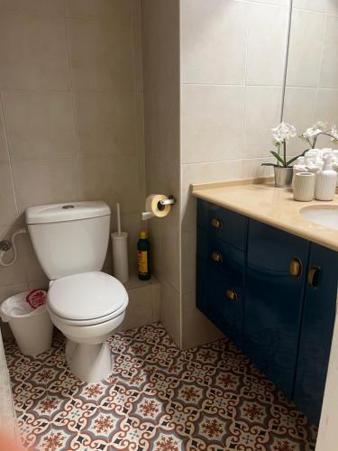 a bathroom with a toilet and a sink at Garden apt at the Marina Herzliya in Herzliyya B
