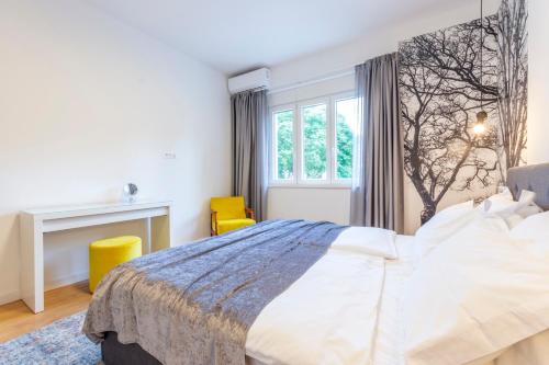 a bedroom with a large bed and a desk at Split Luxury Suite in Split