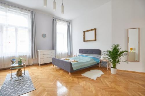 a bedroom with a bed and a wooden floor at Fresh and Personal near Buda Castle in Budapest