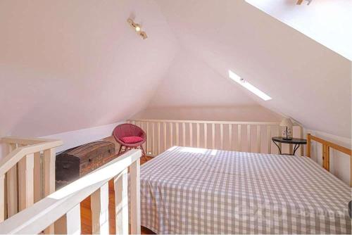 a attic room with a bed and a staircase at Casa do Castelo in Lisbon