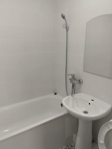 a white bathroom with a sink and a toilet at PARK-hotel in Cahul