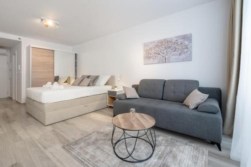 a living room with a couch and a bed at Luni Apartment in Dubrovnik center in Dubrovnik
