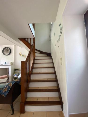 a staircase in a room with a stair case at Petit cocon au cœur du Morvan in Montreuillon