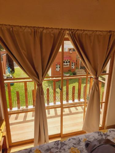 a bedroom with a window with a view of a yard at Villas Montelindo in Constanza